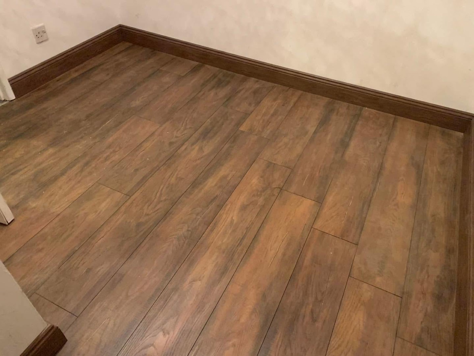 Newly fitted wood-effect flooring and skirting
